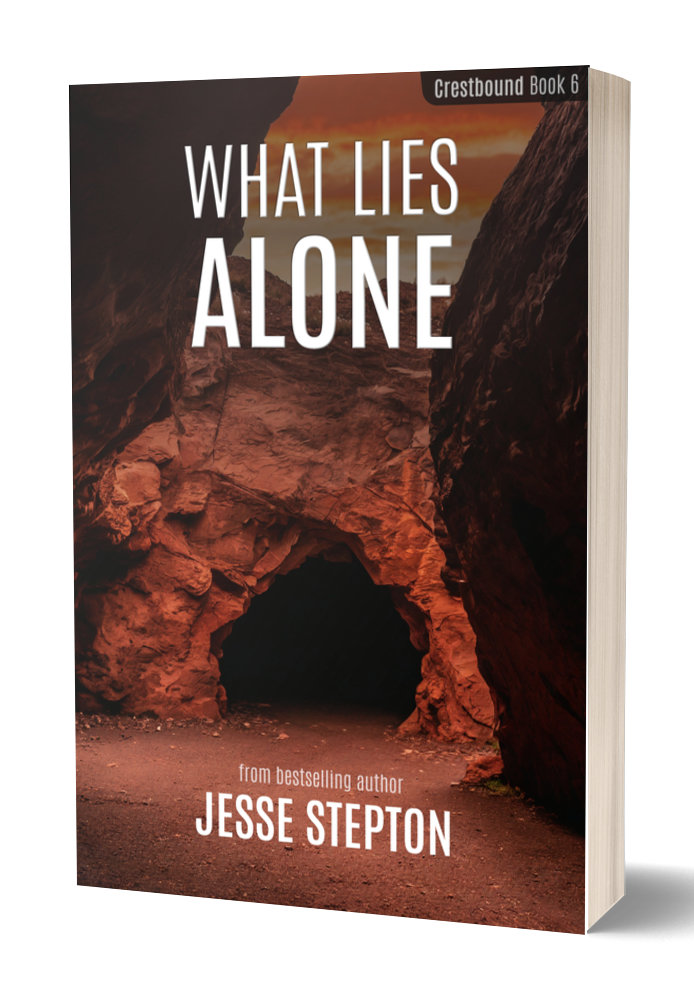 Photo of the book What Lies Alone by Jesse Stepton. The cover shows a cave in some red rocks.